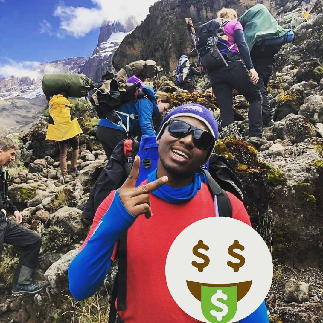 company manager guiding tourists at kiliminjaro mountain